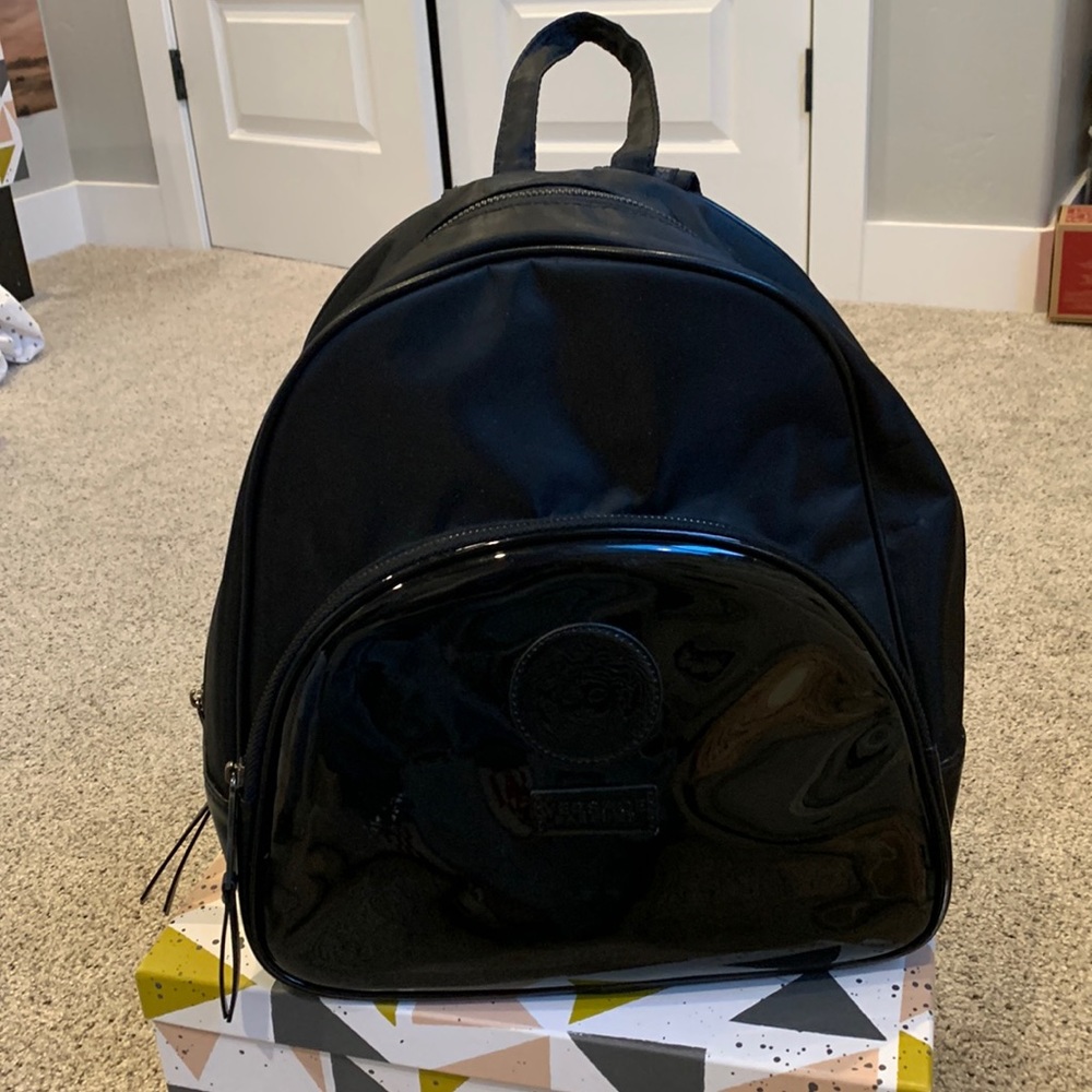 Black backpack. Medium sized. Not very small and not very big.